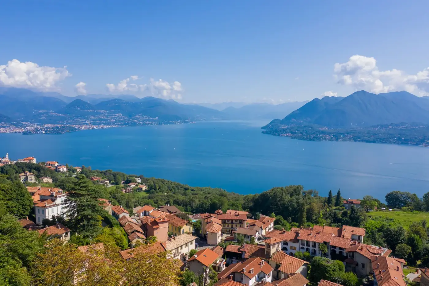 Breathtaking aerial view of Lake Maggiore with mountains and town in northern Italy.