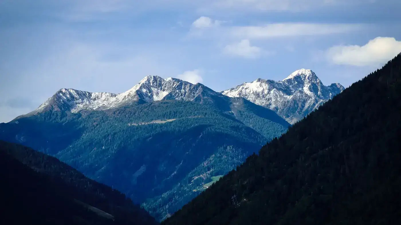 Majestic mountain landscape of snow-capped peaks in Schenna, Italy, showcasing natural beauty and serene scenery.